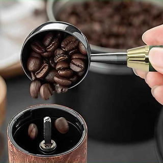 Brewmaster Coffee Scoop Kits. Large, Gold. Pouring Coffee beans into a grinder.