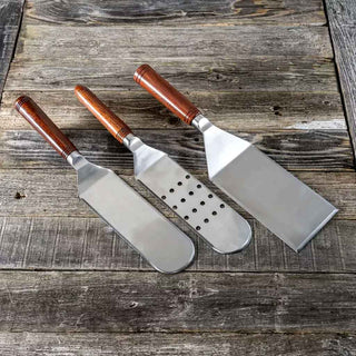 Three-piece Griddle Spatula Kit Set with stainless steel blades and Handle Anything inserts. Includes perforated, solid, and square edge designs in gift packaging
