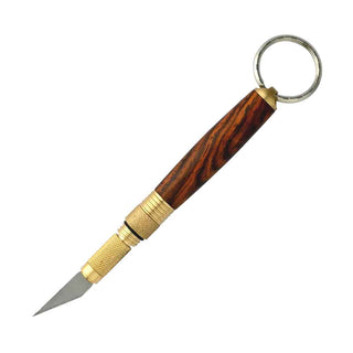 Hobby knife keychain kit with #11 blade and flip-close mechanism. Brass