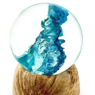 Glass sphere with blue interior on a wooden base. Alumilite Amazing Deep Pour Epoxy Resin