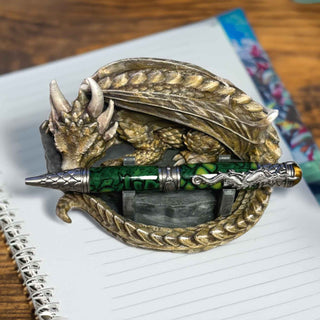 Decorative pen holder with dragon design on a notebook