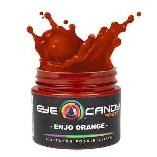 Jar of Eye Candy Paste Enjo Orange with splashing orange substance on a white background