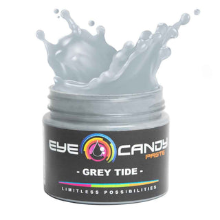 Jar of 'Eye Candy Paste Grey Tide' with splashing gray substance on a white background