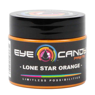Black container of Eye Candy Paste with 'Lone Star Orange' flavor on a white background