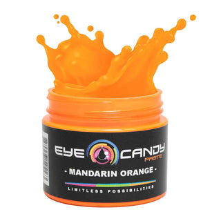 Jar of Mandarin Orange Eye Candy Paste with orange splash on a white background