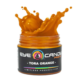 Jar of EYE Candy Paste Tora Orange with orange liquid splash on a white background