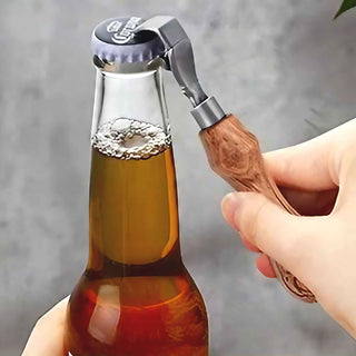 Antique Gun Metal Hand Bottle Opener opening a glass bottle