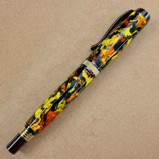 Hocus Pocus Alumilite pen blank handmade by John U turned on a custom Diamond Knurl pen with orange yellow and black swirls