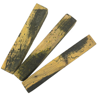 Three wooden pen blanks with black markings on a white background