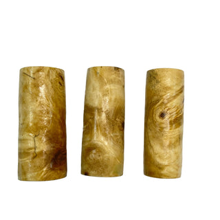 Three buckeye burl pen blanks  with a natural finish on a white background