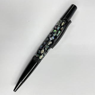 Black pen with decorative cap on a light gray background