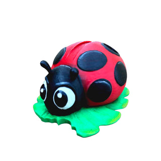 Hand-painted 3D printed ladybug pen holder by John U on a green leaf display stand