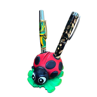 3D printed ladybug pen holder displaying two handcrafted pens.