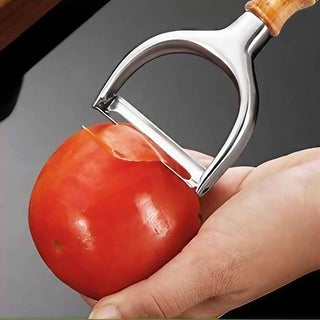 Deluxe heavy duty serrated vegetable peeler with custom turned wood handle peeling tomato