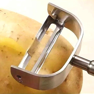 Y-Shaped stainless steel vegetable peeler removing skin from a potato