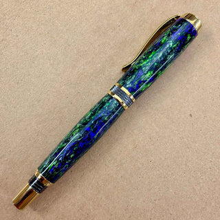 Finished Witch’s Brew Alumilite pen blank by John U featuring purple green and dark swirling resin